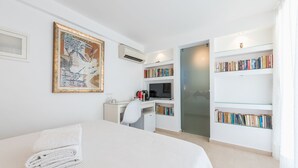 A modern bedroom with a bed, a desk, and a bookshelf. - ALC Best View in Athens (Athens)