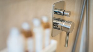 A bathroom with a modern shower control panel and a visible bottle of shampoo. - ALC Best View in Athens (Athens)