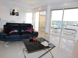 Deluxe Apartment, 3 Bedrooms, Sea View | Living room | Flat-screen TV