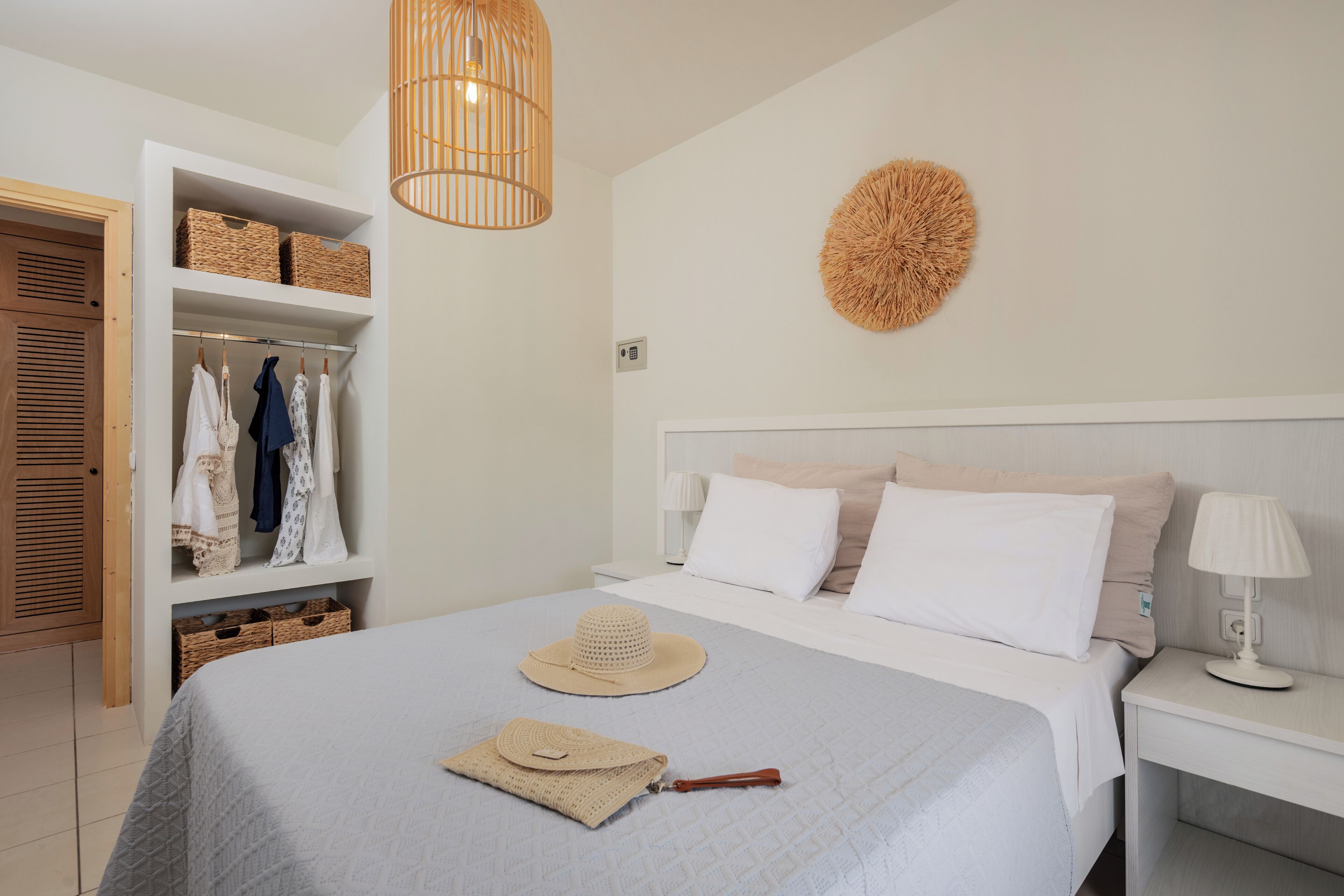 A neatly organized bedroom with a bed, bedside tables, a wardrobe, and a hanging basket.