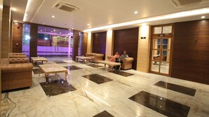A lobby with a marble floor, sofas, and a reception desk. - County Inn Hotel (Jaipur)