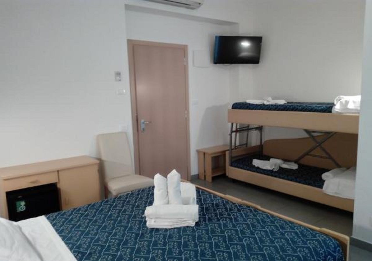 standard quadruple room | in-room safe, desk, free wifi, bed sheets