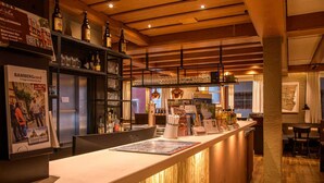 A bar area with wooden beams, shelves with bottles, and a counter with a menu. - Hotel Brauerei Gasthof Höhn (Memmelsdorf)