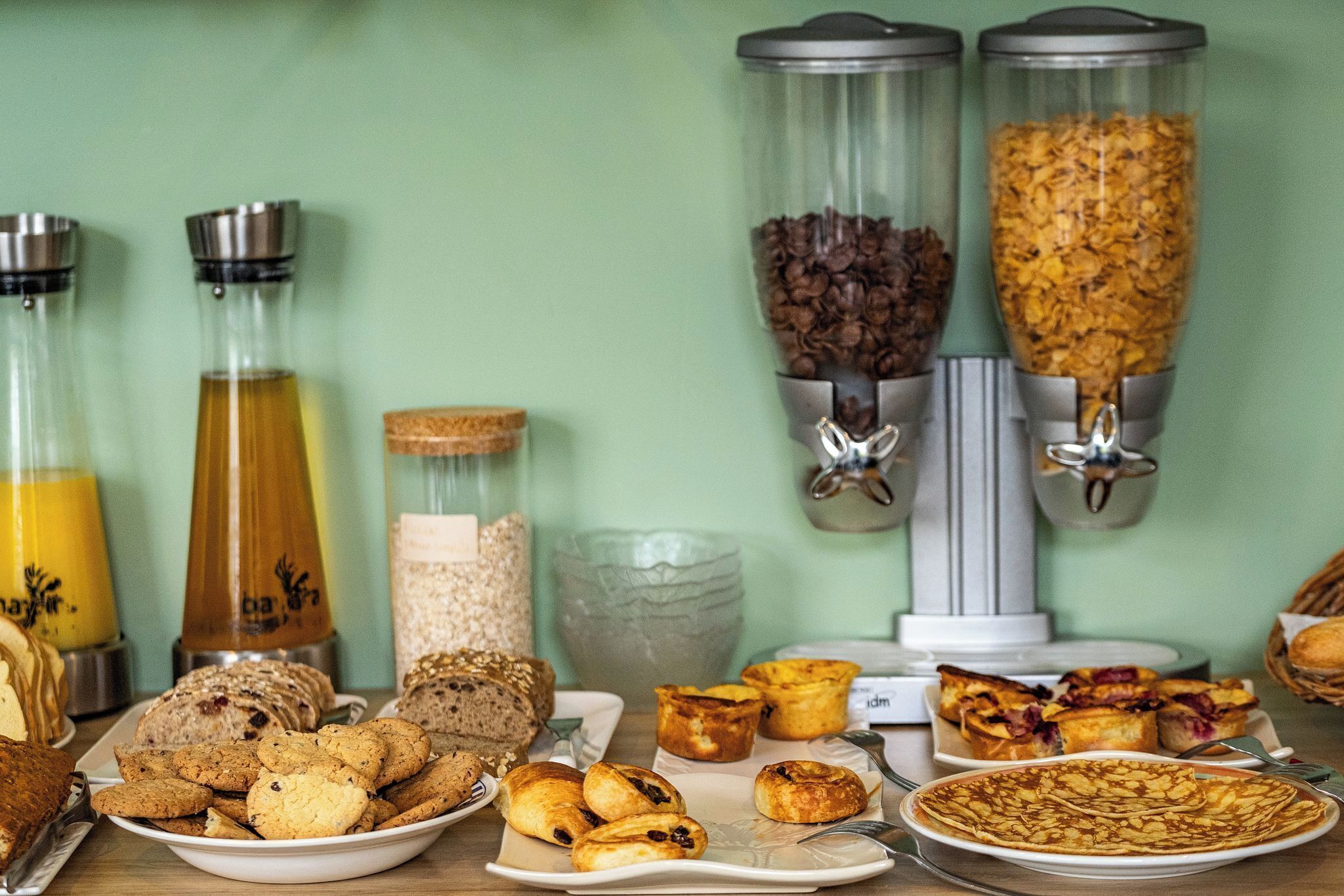 A breakfast buffet with various food items and beverages.