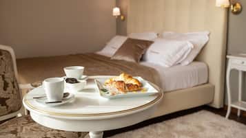 A neatly made bed with pillows and a bedside table with a lamp.