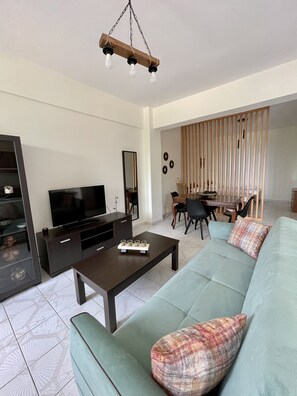 Family Apartment (Ground floor) | Living area | 23-inch flat-screen TV with cable channels, TV - Sofia Apartments (Pylos-Nestoras)