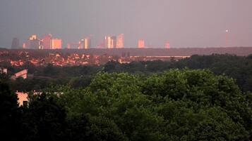 A city skyline with high-rise buildings and a river in the foreground.