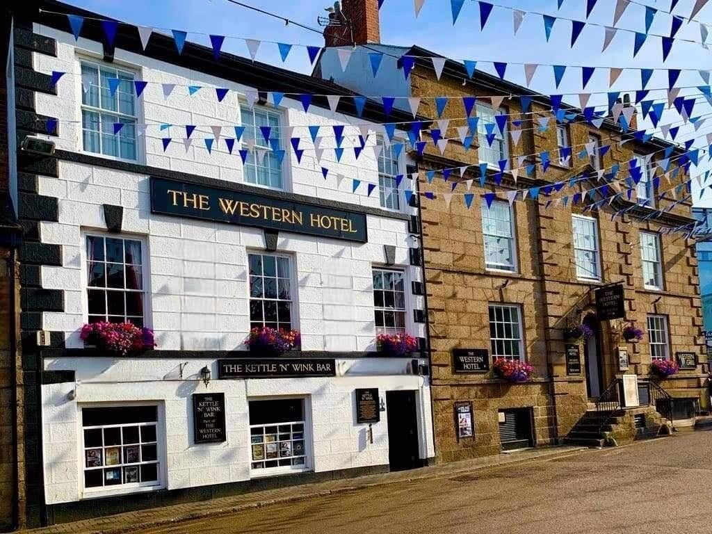 The Western Hotel with a sign for The Kettle N' Winkle Bar.