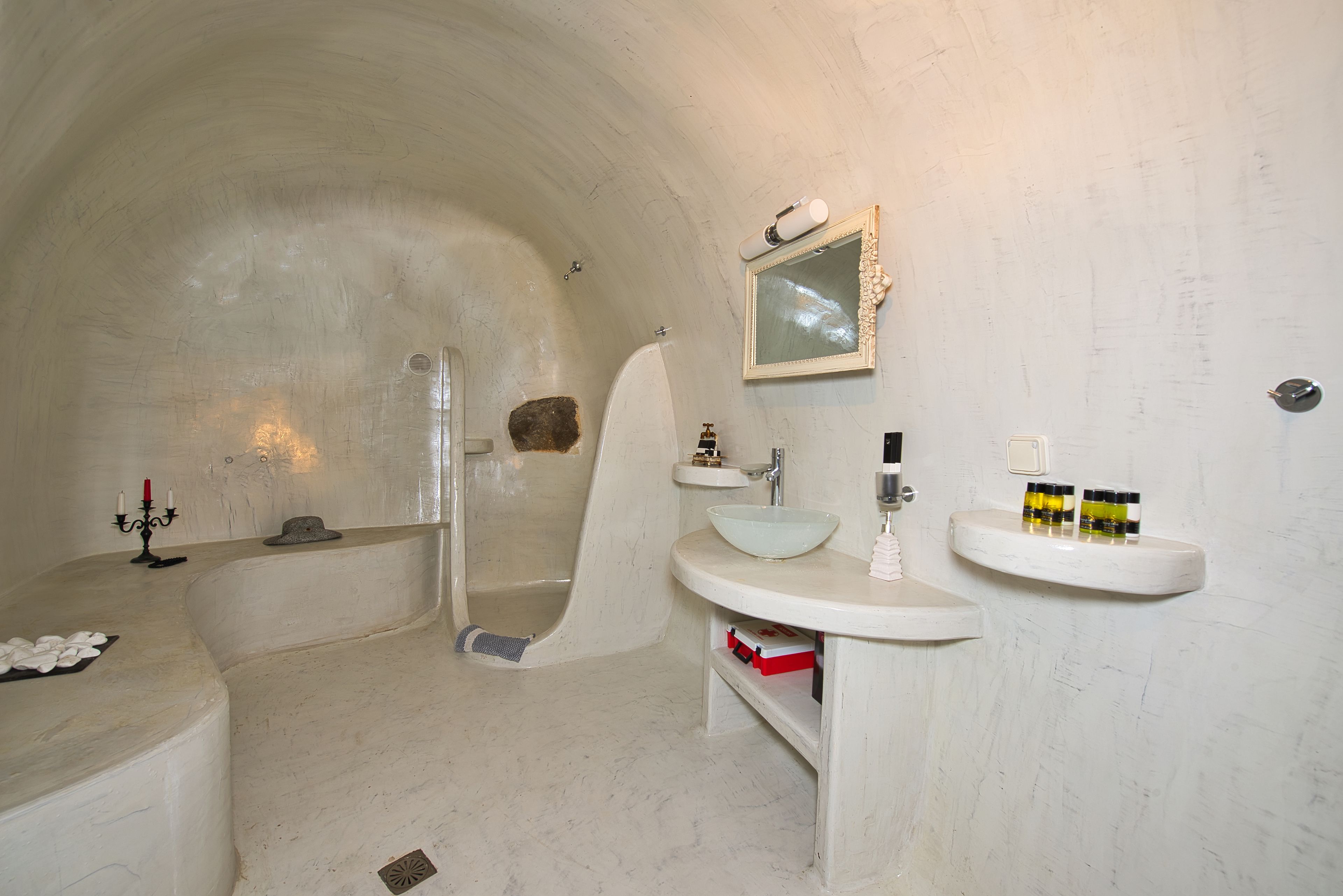 A bathroom with a bathtub, a sink, and a mirror.