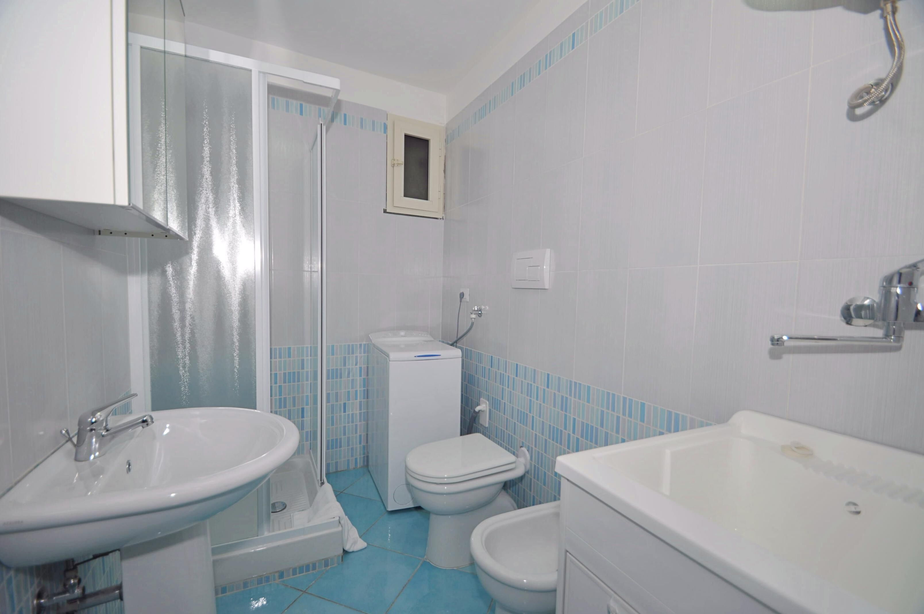 A bathroom with a sink, toilet, shower, and bathtub.