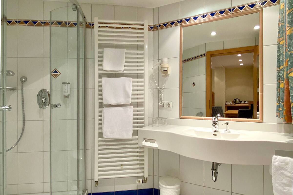 family room | bathroom | shower, rainfall showerhead, free toiletries, hair dryer