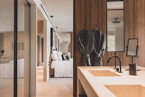 Signature Suite | Bathroom | Designer toiletries, hair dryer, bathrobes, slippers