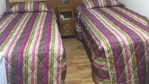 A double room with two beds, each with a headboard and a quilted bedspread. - White house Hotel (London)