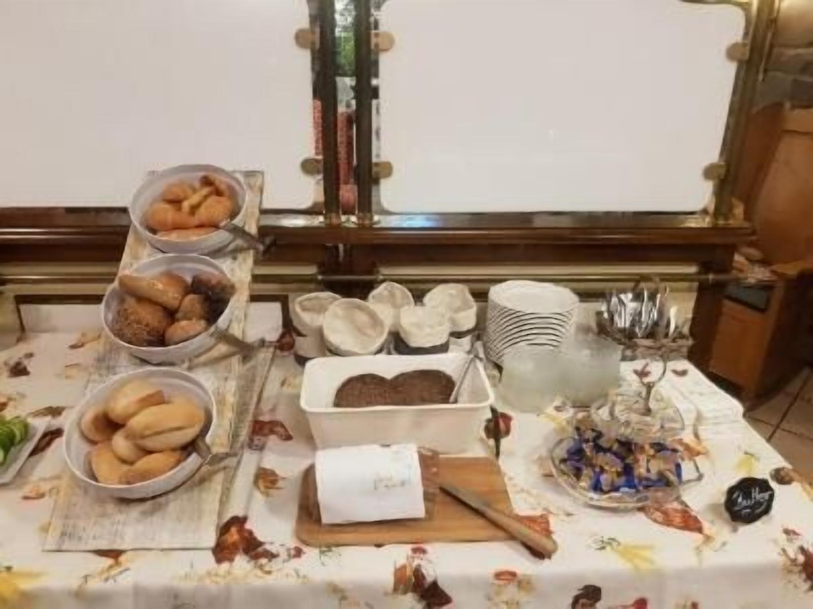 A buffet table with various food items and serving utensils.