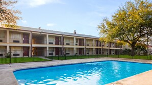 A multi-story motel with a swimming pool. - Red Roof Inn Temple (Temple)