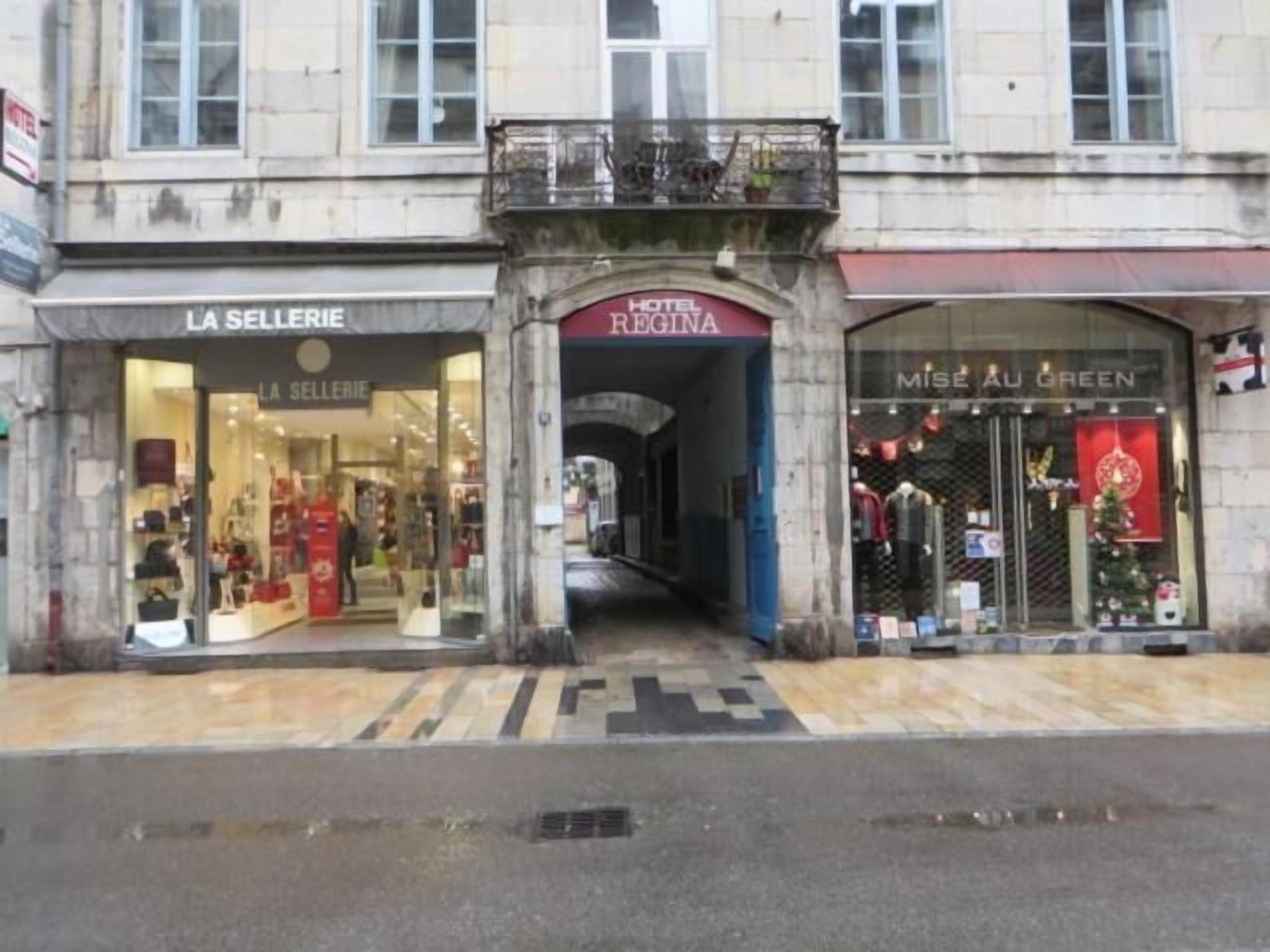 A street view of a building with a boutique hotel named "Hotel Regina" and a store called "Miss Au Green".