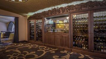 A wine cellar with wooden cabinets and a patterned carpet.
