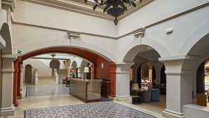 A spacious lobby with a patterned floor, a large chandelier, and a staircase leading to upper levels. - Costa del Sol Trujillo Centro (Trujillo)
