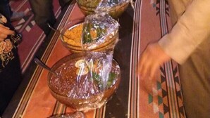 A buffet line with various dishes covered in plastic. - Moon Valley Camp (Wadi Rum)