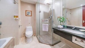A modern bathroom with a glass-enclosed shower, a white toilet, a sink with a mirror, and a towel rack. - East Lake International Hotel (Yangjiang)
