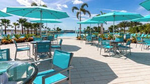 A poolside area with turquoise umbrellas, lounge chairs, and a clear view of the pool. - Amazing Margaritaville Holiday Home - Indoor/Outdoor Entertaining Space (Kissimmee)