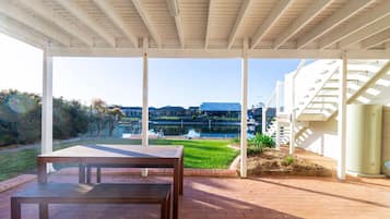 Relax by the lake with a view of the surrounding landscape from this covered outdoor area.