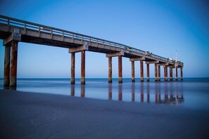 Guests can walk along the pier, taking in the serene views of the calm water.