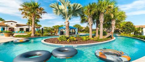 Relax by the resort's circular pool surrounded by lush palm trees and tropical vegetation.