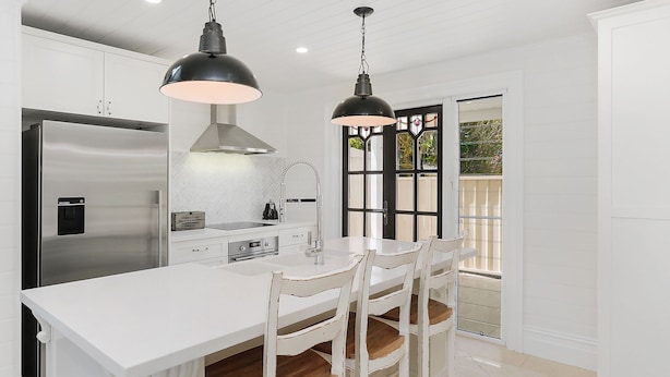 A modern kitchen with stainless steel appliances, white cabinetry, and pendant lighting. - Little Lewis - Romantic Getaway (Callala Beach)