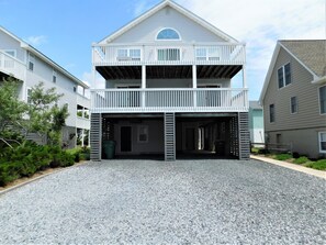 A two-story building with a balcony on the upper floor and a covered parking area. - 7 (40133) South Carolina Avenue (Fenwick Island)