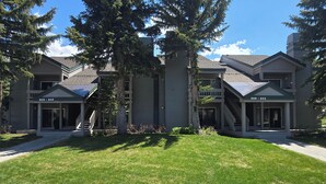 A two-story building with a covered porch and a small staircase leading to the entrance. - Snowcreek Resort Vacation Rental 611 (Mammoth Lakes)