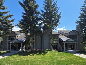 A two-story building with a covered porch and a small staircase leading to the entrance. - Snowcreek Resort Vacation Rental 611 (Mammoth Lakes)