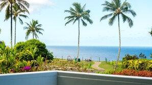 A view of a beach with palm trees and a clear sky.