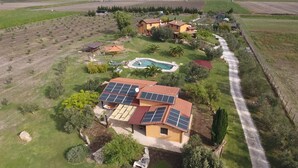 A residential property with a swimming pool, solar panels, and a well-maintained garden.