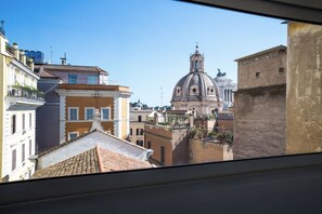 A view of a cityscape with historic buildings, a prominent dome, and a clear sky.