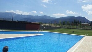 A swimming pool with a view of mountains in the background.