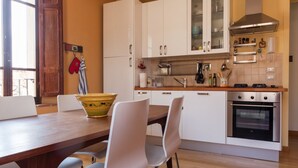 A modern kitchen with white cabinets, a wooden countertop, and a built-in oven. - Medieval village TOP flat, third floor with Wi-Fi & aircon (Compignano)
