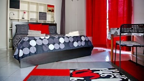 A bedroom with a bed, a chair, a wardrobe, and a shelf unit. - Nice and bright apartment with wi-fi and a/c in Darsena and Navigli district (Milano)