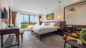 A hotel room with a bed, desk, and a large window with a view. - BACKHOME BOUTIQUE OLD TOWN HOI AN (Da Nang)