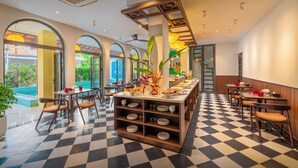 A restaurant with a checkered floor, multiple dining tables, and chairs. - BACKHOME BOUTIQUE OLD TOWN HOI AN (Da Nang)