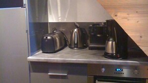 A compact kitchen with a built-in oven, a coffee maker, and a toaster on the countertop. - Apartment/ flat - VAL THORENS (Les Belleville)