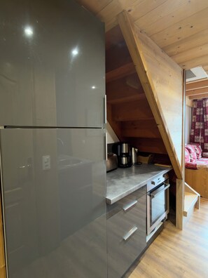 A modern kitchen with a stainless steel refrigerator, a built-in oven, and a wooden ceiling. - Apartment/ flat - VAL THORENS (Les Belleville)
