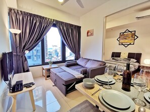 Family Apartment, 2 Bedrooms, Sea View | Living area | LED TV - Tropicana 218 Suites (George Town)