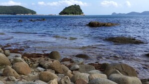 A rocky shoreline with a small island in the distance. - A day in Geoje Pension (Geoje)