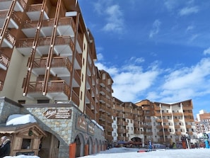 A multi-story hotel with balconies, a stone facade, and a sign for 'Motel'.