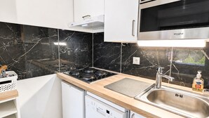 A modern kitchen with a built-in stove, oven, and dishwasher.