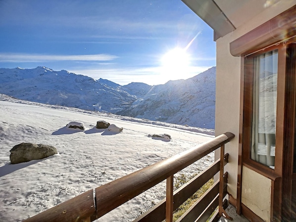 Enjoy breathtaking views of the rugged mountains from this serene balcony.