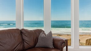 A room with a large window overlooking a beach. - Ocean Front Luxury Home (Gleneden Beach)