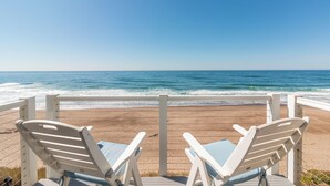 A beach view with two white lounge chairs facing the ocean. - Ocean Front Luxury Home (Gleneden Beach)