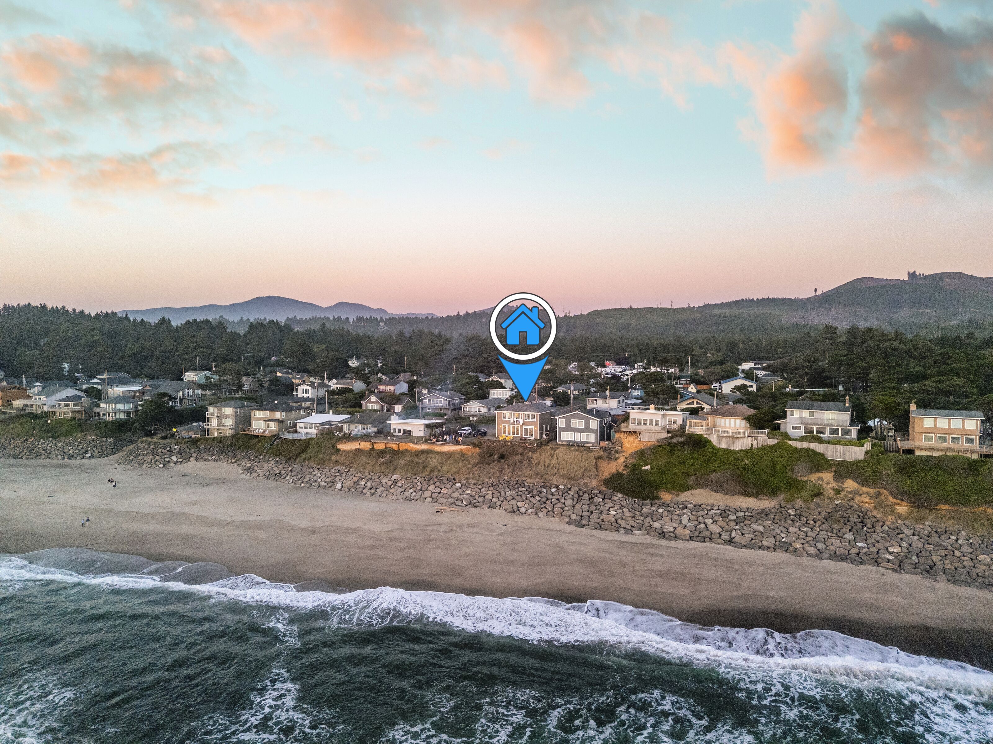 A coastal town with houses near the beach and ocean.